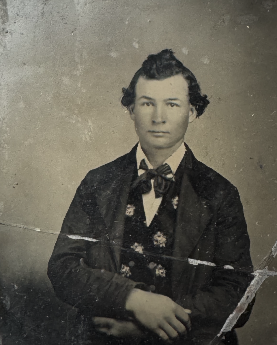 Early 1860s tintype portrait with surface damage, possibly resulting from bends in the metal. His hairstyle and broad bowtie help place the date to the early 1860s. Note the strong familial resemblance to the two photographs immediately above this one.
