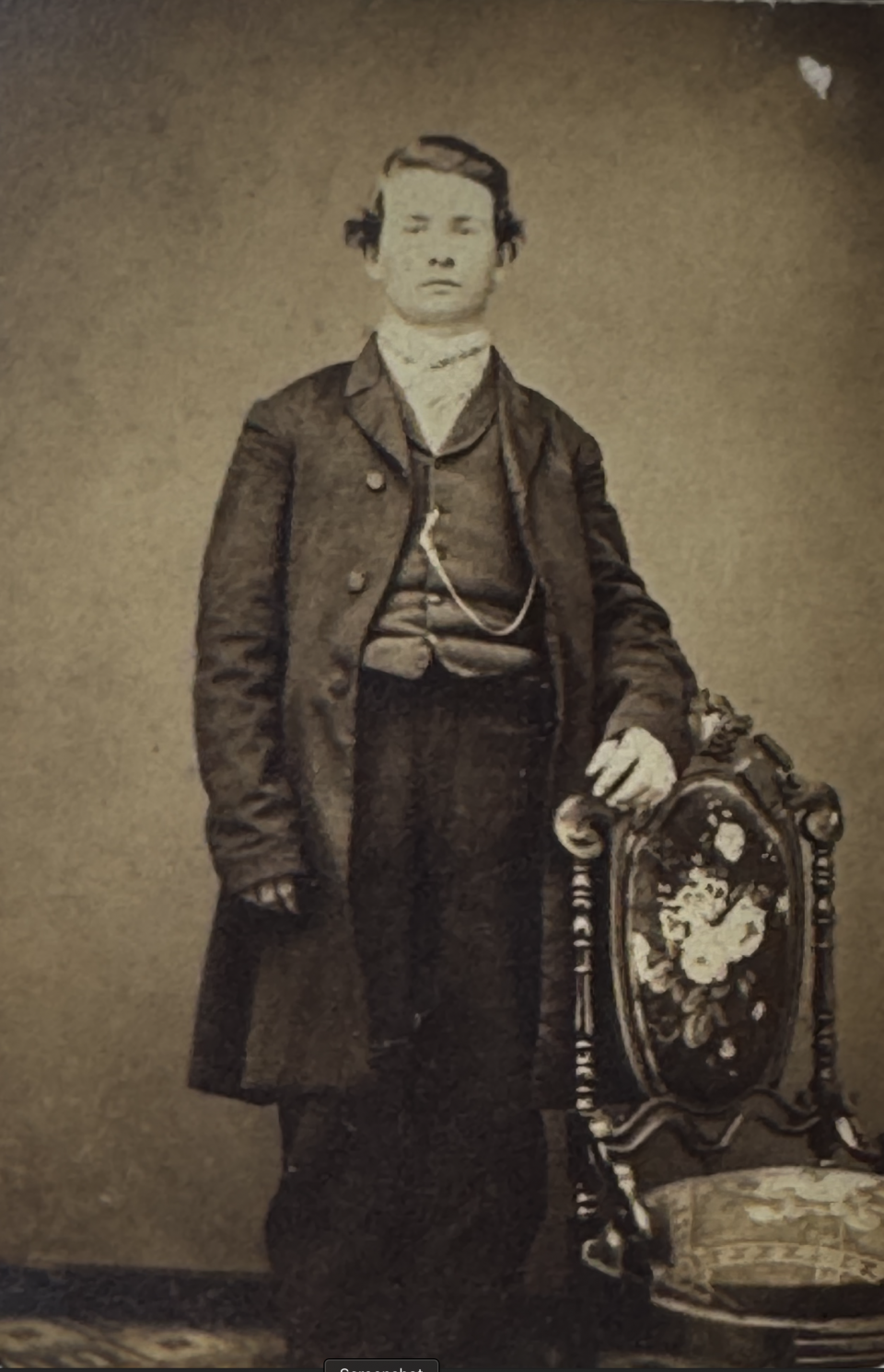 Early-to-mid-1860s carte de visite portrait of a man wearing a long frock coat with a somewhat rolled lapel, waistcoat, and prominent watch chain which help place him in that date range. The highly ornate, upholstered chair is typical of the elaborate photographic studio settings used for CDVs during the 1860s. The above portrait was made by the studio of I.P.E. Whedon of Goshen, Indiana, lnfo on the back shown below.