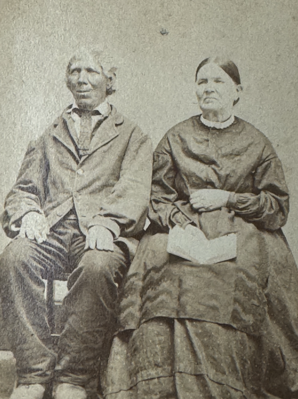 Another set of unidentified elders seen in a carte de visite albumen portrait. The wife is holding what appears to be an open book of scriptures on her lap.