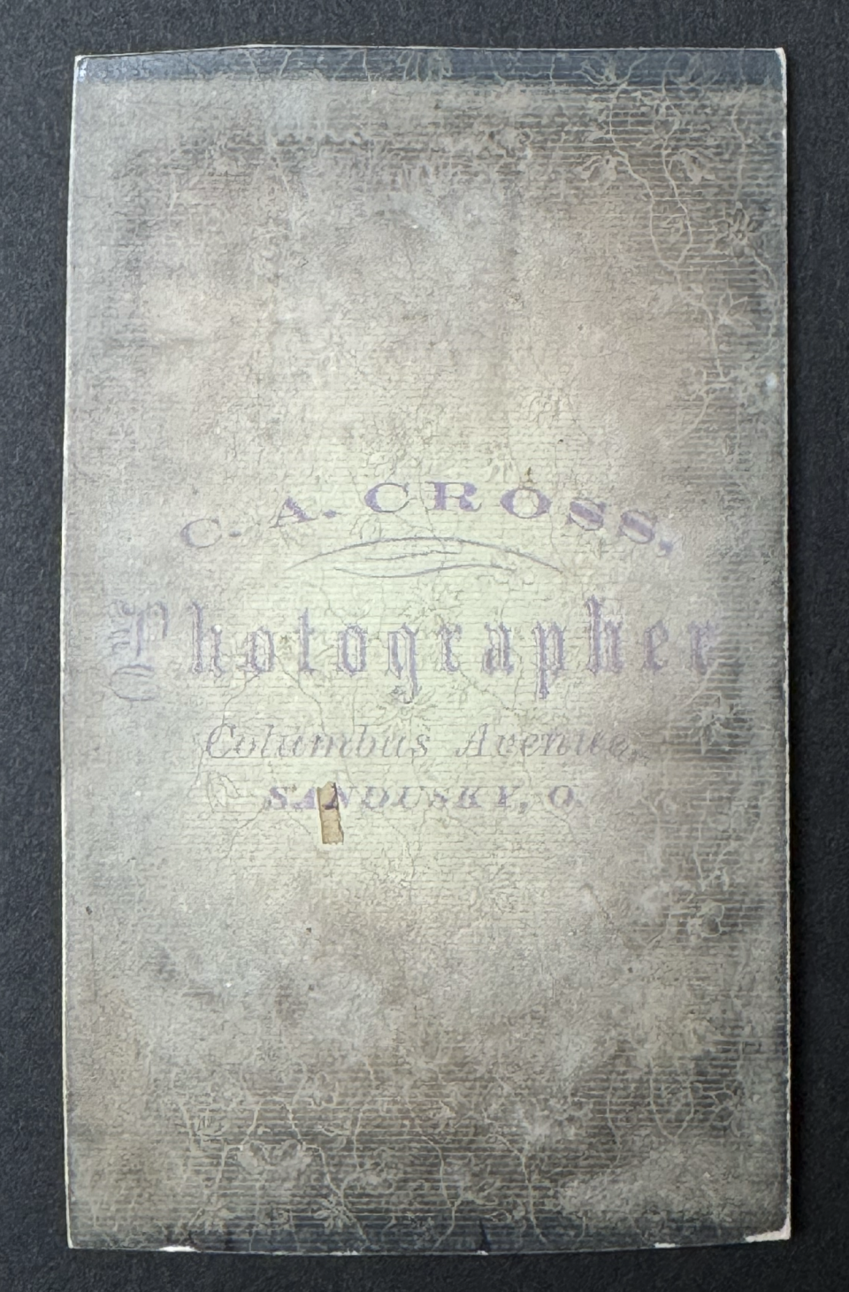 Carte de visite imprint of the studio of C.A. Cross, of Sandusky, Ohio. Cross is identified at two studios addresses, with the Columbus Avenue studio being earlier in his career.