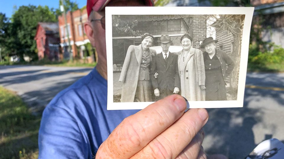 Jimmy O. Thompson holds a photograph of C.P. Jones with three women standing in front of his namesake drug store, which is one of the ruins still standing in Union Level.