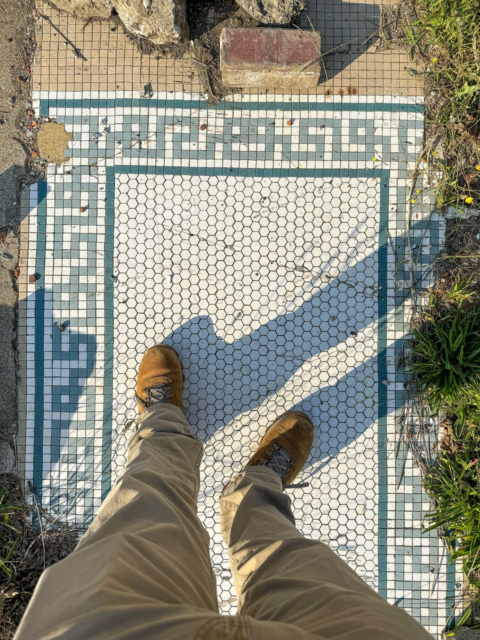 Standing on the entry tile for a store that no longer exists, in Cairo, Illinois.