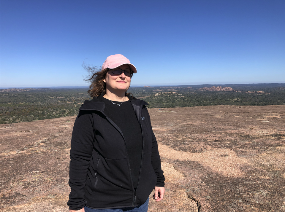 Teena atop the giant granite dome at Enchanted Rock, Texas.